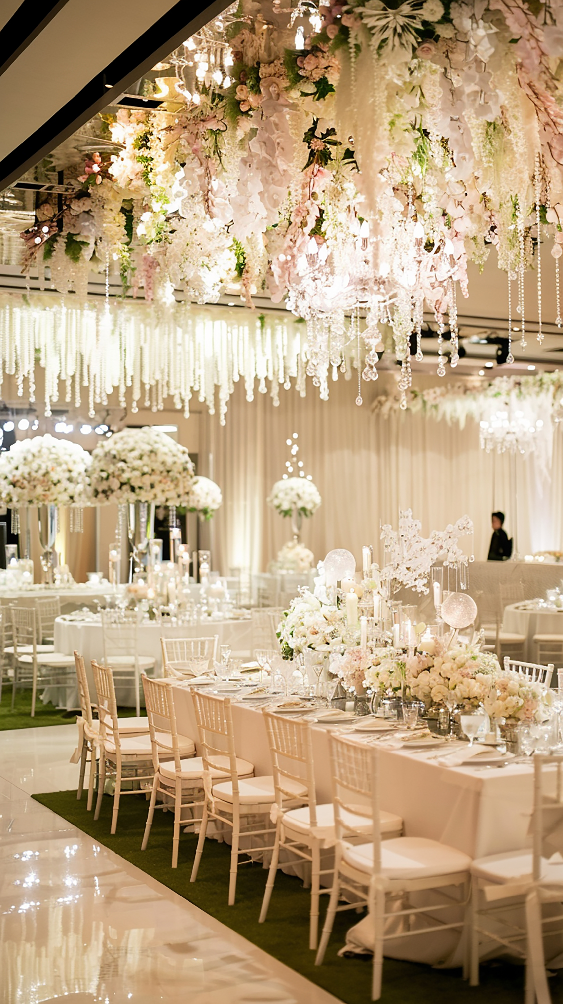 Grand reception hall with chandeliers and floral arrangements